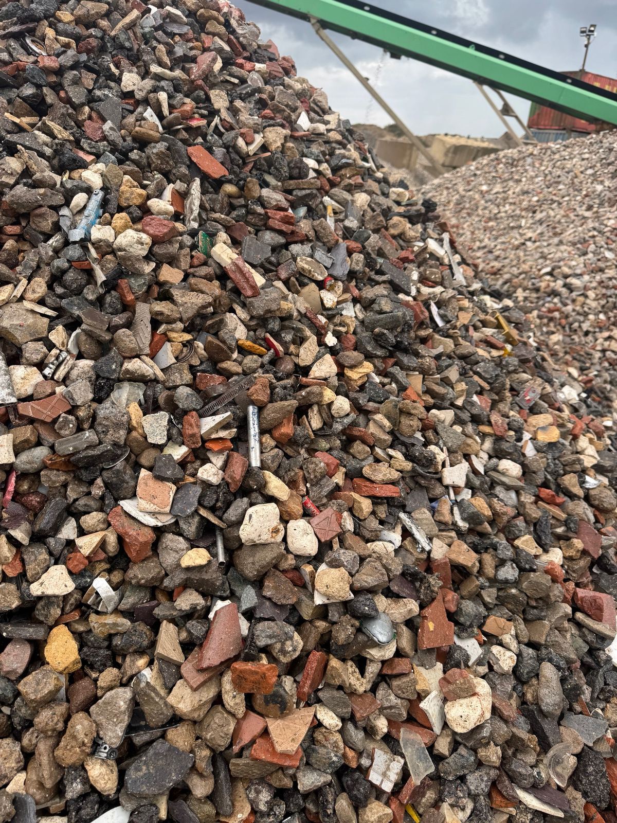 Pile of crushed recycled aggregate with a conveyor
