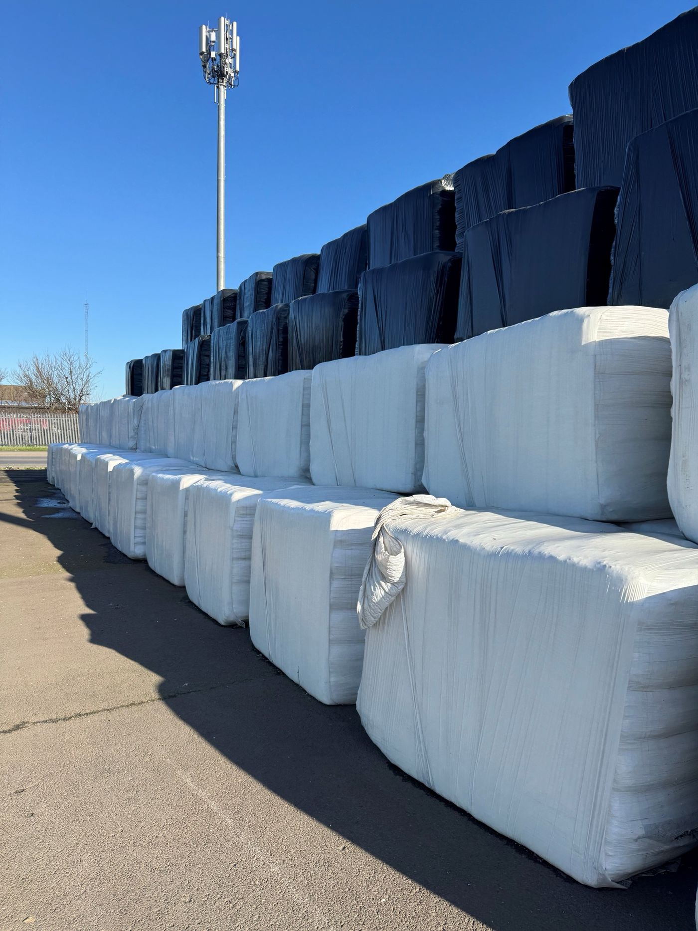 Wrapped bales stacked in a yard