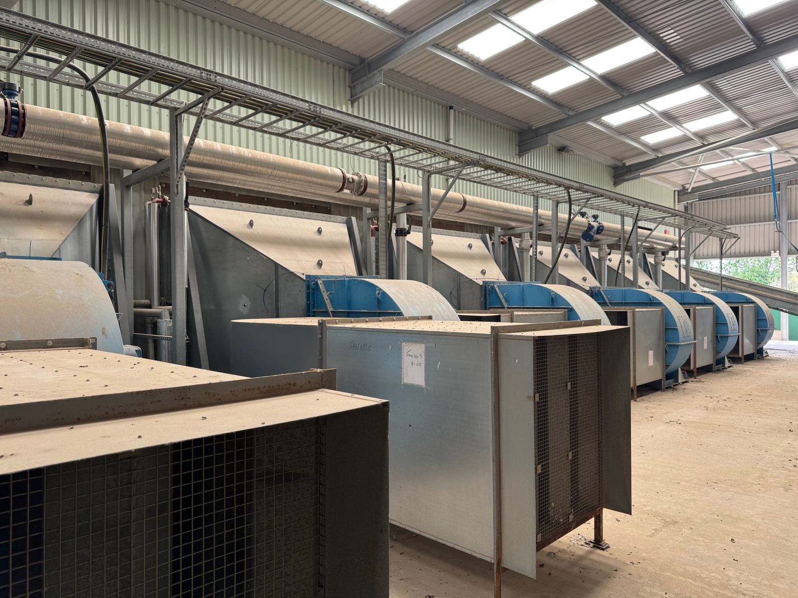 Row of combustion air fans in a plant hall
