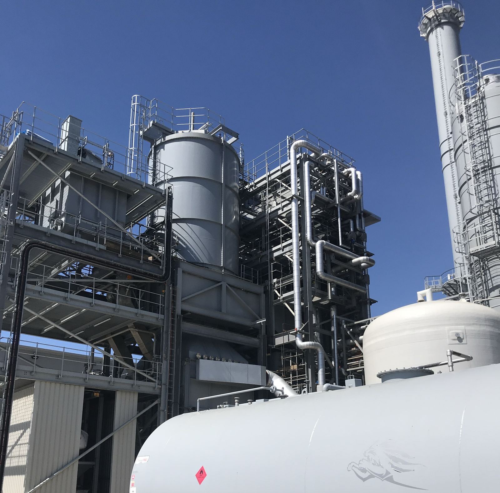 Energy plant with boiler house, pipework and stack